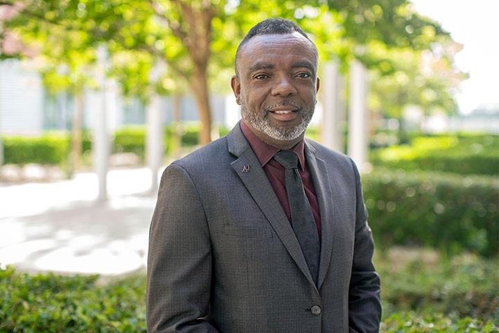 Chief Bohannon in a suit outdoors on campus